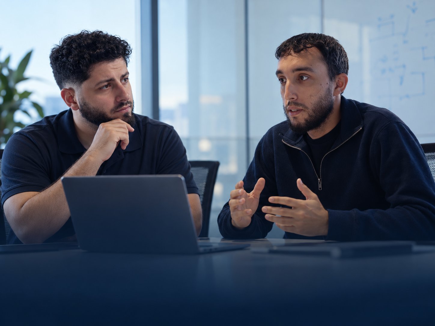Composite portrait based on photographs of the two YNY Solutions cofounders collaborating